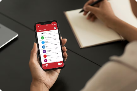 Person using messaging app on phone while writing.
