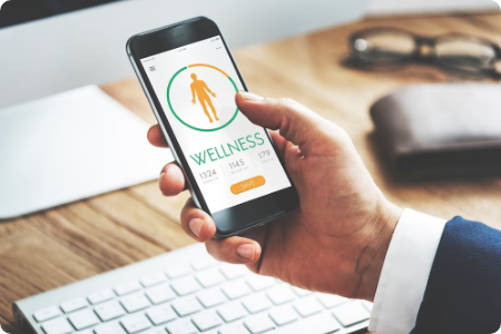 Person holding phone with wellness tracking app.