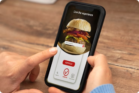 Person using food ordering app with burger image.