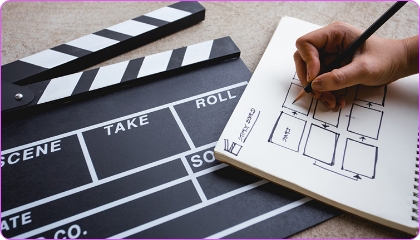 Close-up of a film clapperboard and storyboard sketch.
